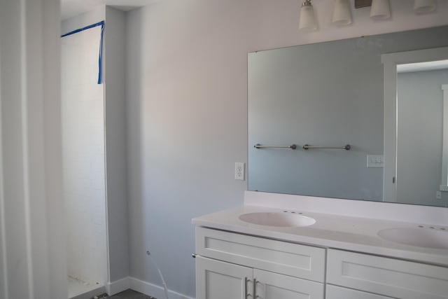 1024 Clinton Ave, Kalamazoo, MI 49001 - bathroom with a sink, double vanity, and a stall shower