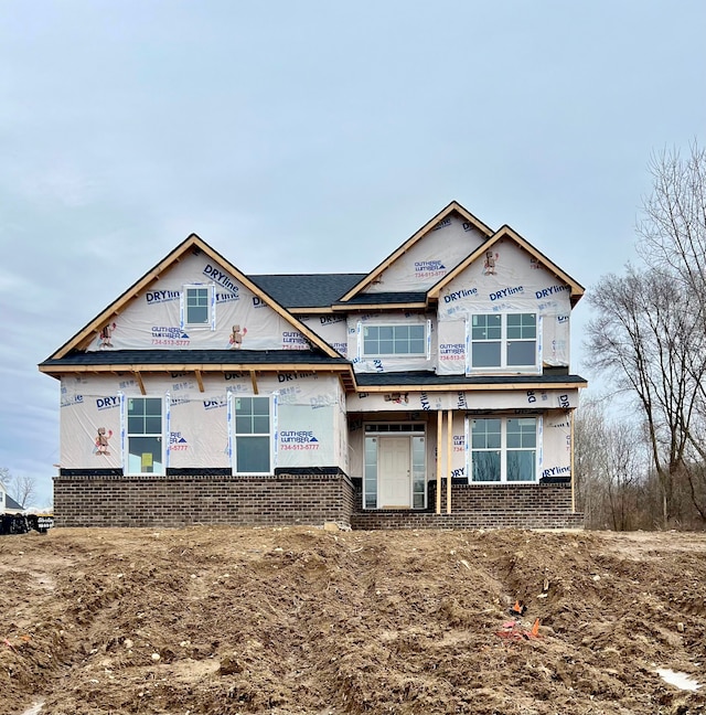 property in mid-construction featuring brick siding