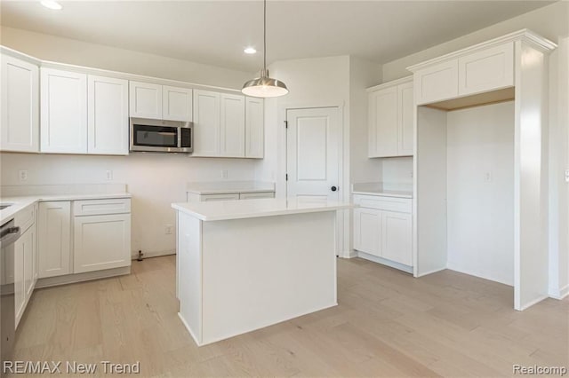 kitchen featuring white cabinets, recessed lighting, stainless steel appliances, and light wood-style flooring