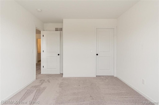 unfurnished bedroom with visible vents, baseboards, and carpet