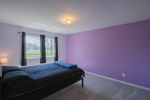 carpeted bedroom featuring baseboards