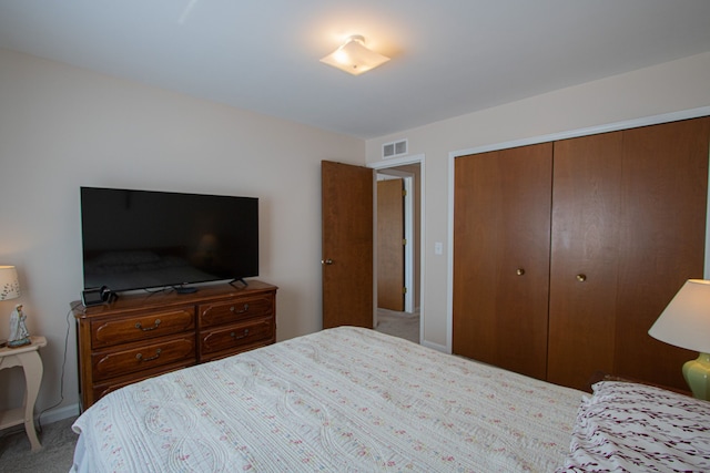 carpeted bedroom featuring visible vents and a closet