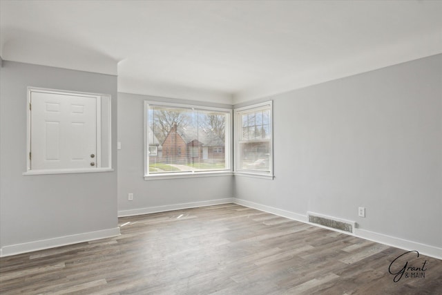 19931 Braile St, Detroit, MI 48219 - spare room with baseboards, wood finished floors, and visible vents