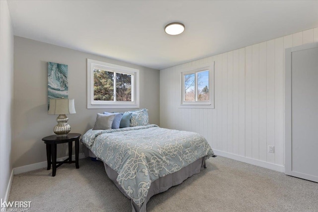 bedroom featuring baseboards and light colored carpet