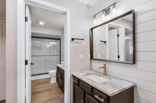 816 Tioga Park, Big Rapids, MI 49307 - full bathroom with a shower stall, toilet, vanity, and wood finished floors