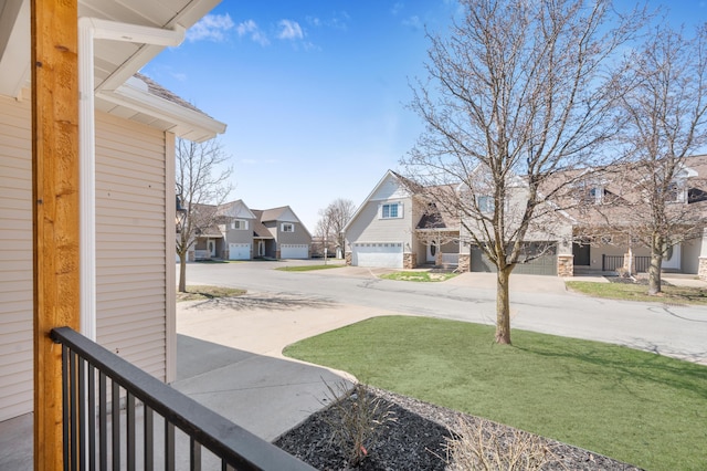 816 Tioga Park, Big Rapids, MI 49307 - view of yard with an attached garage, a residential view, and concrete driveway