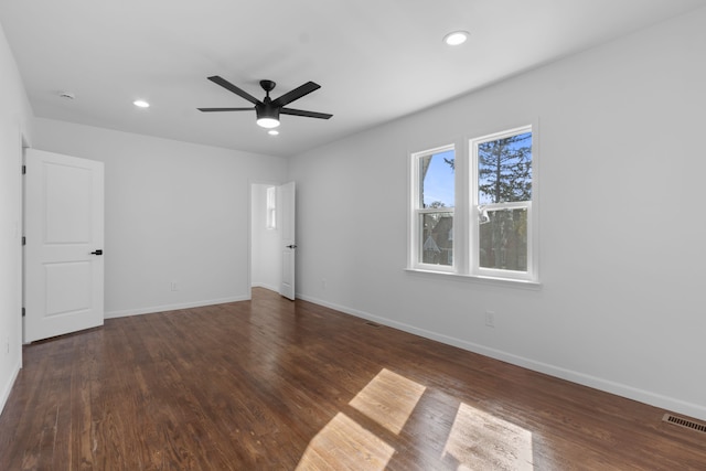 unfurnished bedroom featuring baseboards, wood finished floors, and visible vents