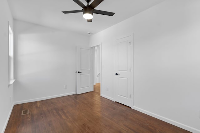 unfurnished bedroom featuring visible vents, baseboards, wood finished floors, and ceiling fan