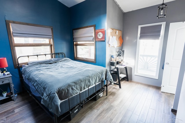 7841 Peninsular Dr, Farwell, MI 48622 - bedroom featuring wood finished floors, baseboards, and multiple windows