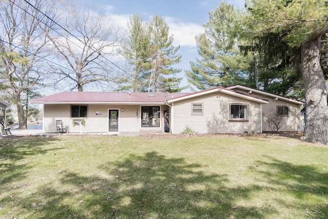 7841 Peninsular Dr, Farwell, MI 48622 - back of house featuring a lawn and metal roof