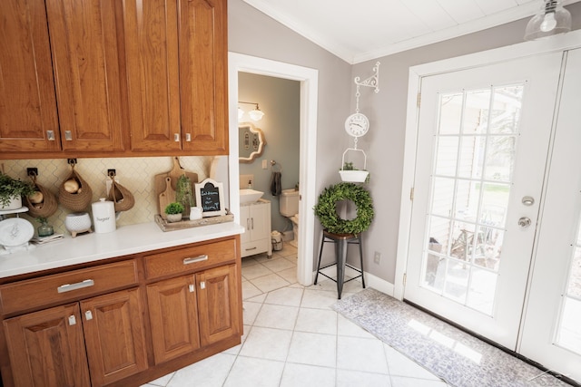 7841 Peninsular Dr, Farwell, MI 48622 - entryway featuring light tile patterned floors, vaulted ceiling, a wealth of natural light, and ornamental molding