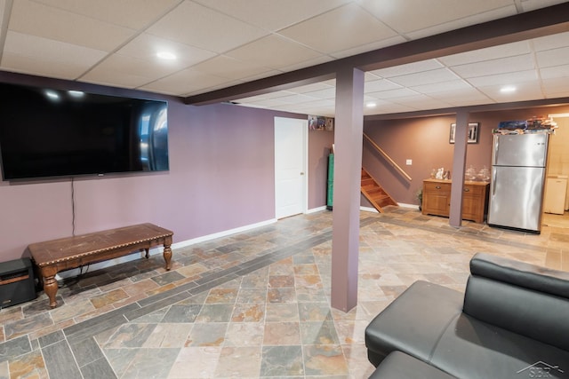 7841 Peninsular Dr, Farwell, MI 48622 - living room featuring stone finish flooring, baseboards, stairs, and a paneled ceiling