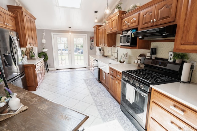 7841 Peninsular Dr, Farwell, MI 48622 - kitchen featuring under cabinet range hood, stainless steel appliances, backsplash, light tile patterned floors, and a sink