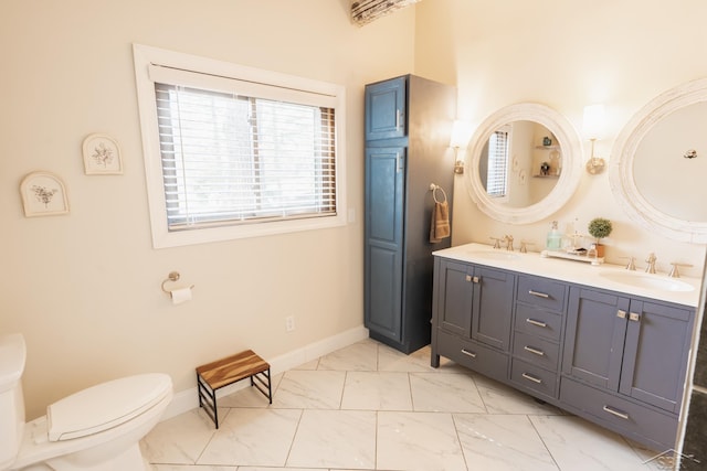 7841 Peninsular Dr, Farwell, MI 48622 - bathroom featuring double vanity, marble finish floor, toilet, and a sink