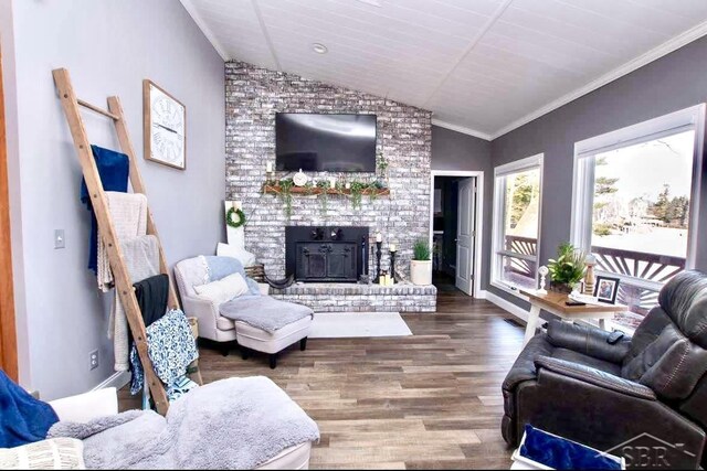 7841 Peninsular Dr, Farwell, MI 48622 - living area with vaulted ceiling, crown molding, a brick fireplace, and wood finished floors