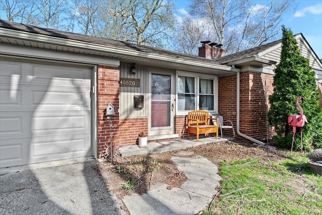 45520 Deshon St, Utica, MI 48317 - entrance to property featuring a chimney, brick siding, and a garage