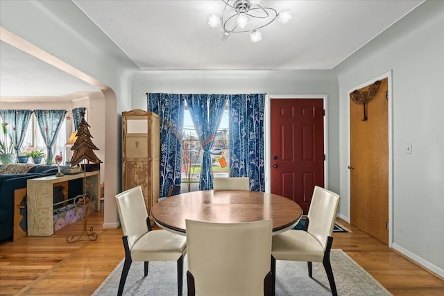 45520 Deshon St, Utica, MI 48317 - dining room with baseboards, a notable chandelier, wood finished floors, and plenty of natural light