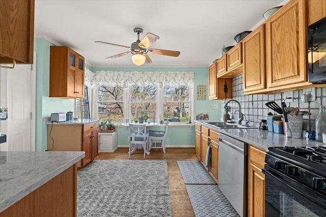 45520 Deshon St, Utica, MI 48317 - kitchen featuring a ceiling fan, a sink, brown cabinets, and black appliances