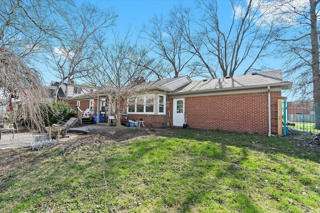 45520 Deshon St, Utica, MI 48317 - rear view of property featuring fence, brick siding, and a yard