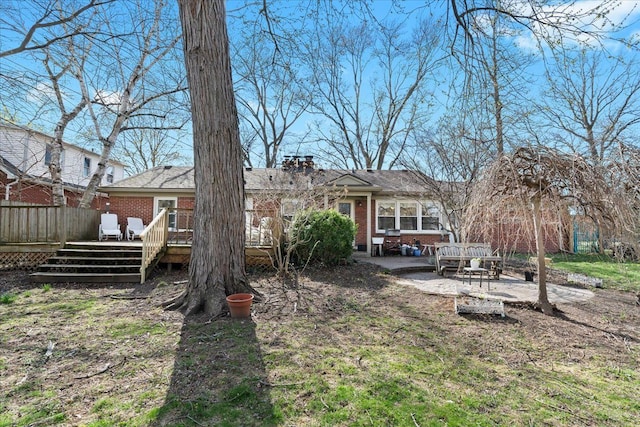 45520 Deshon St, Utica, MI 48317 - back of house with a chimney, fence, brick siding, a wooden deck, and a patio area