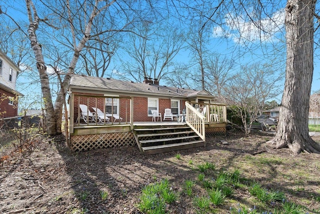 45520 Deshon St, Utica, MI 48317 - rear view of house featuring brick siding, a chimney, a wooden deck, and fence