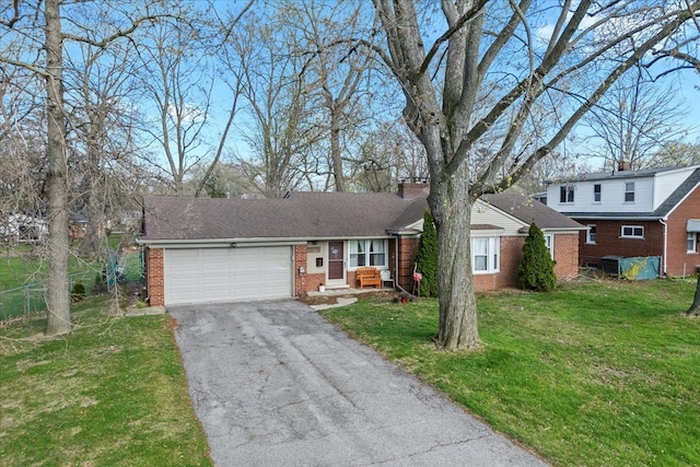 45520 Deshon St, Utica, MI 48317 - view of front facade with a garage, a chimney, driveway, a front yard, and brick siding