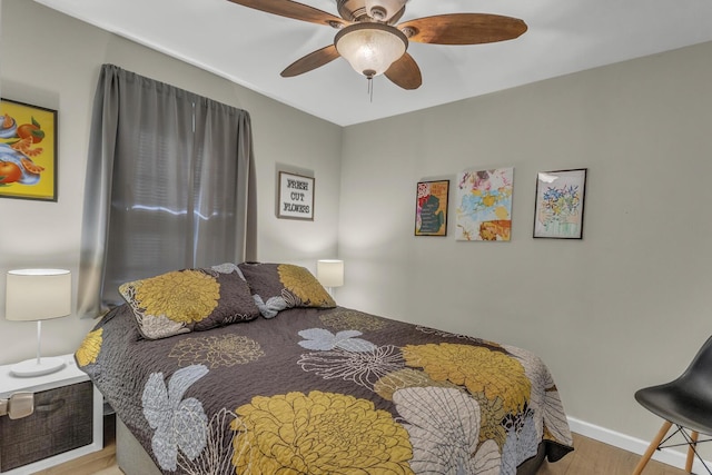bedroom with wood finished floors, baseboards, and ceiling fan