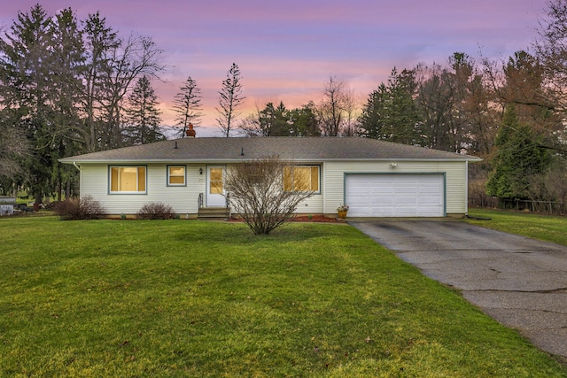 ranch-style house with a garage, entry steps, driveway, and a front lawn