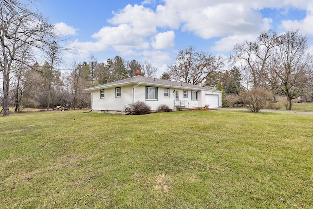 ranch-style house with an attached garage, driveway, a front lawn, and a chimney