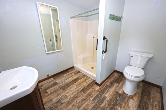 69369 Oak St, Benton Harbor, MI 49022 - bathroom featuring a shower, baseboards, vanity, and wood finished floors
