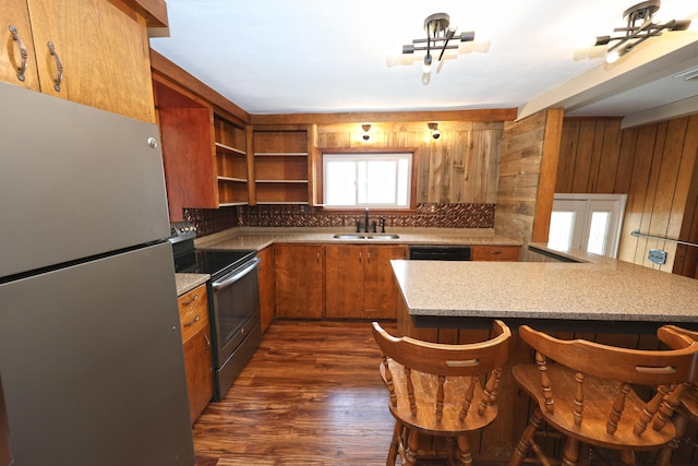 69369 Oak St, Benton Harbor, MI 49022 - kitchen with appliances with stainless steel finishes, decorative backsplash, brown cabinetry, and a sink