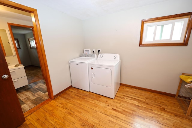 69369 Oak St, Benton Harbor, MI 49022 - washroom with laundry area, light wood finished floors, baseboards, and independent washer and dryer
