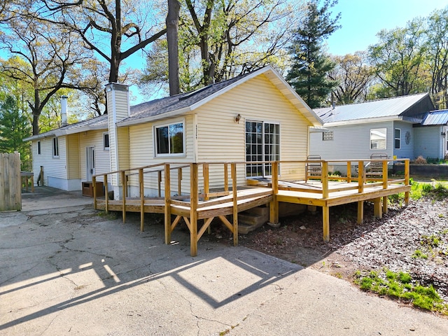 69369 Oak St, Benton Harbor, MI 49022 - back of house with a chimney and a wooden deck