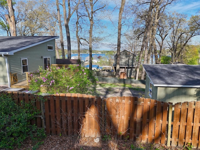 69369 Oak St, Benton Harbor, MI 49022 - view of yard featuring a deck with water view and a fenced backyard