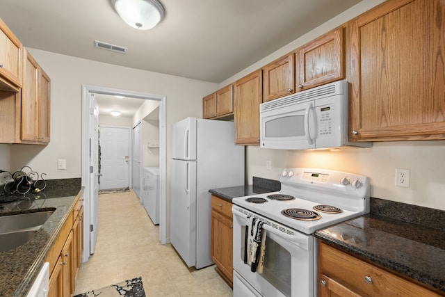 52140 Naugatuck Dr, Macomb, MI 48042 - kitchen with white appliances, visible vents, a sink, and dark stone countertops