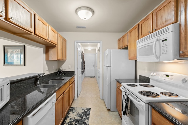 52140 Naugatuck Dr, Macomb, MI 48042 - kitchen with a sink, white appliances, dark stone counters, light tile patterned floors, and visible vents