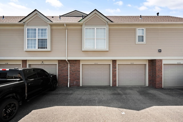 52140 Naugatuck Dr, Macomb, MI 48042 - exterior space featuring an attached garage, driveway, and brick siding