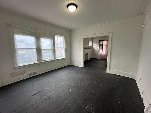 15815 Linwood St, Detroit, MI 48238 - unfurnished room with baseboards, ornamental molding, dark wood-type flooring, and visible vents