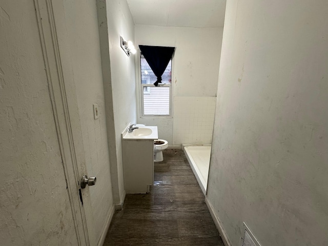 15815 Linwood St, Detroit, MI 48238 - bathroom featuring visible vents, wood finished floors, vanity, and toilet
