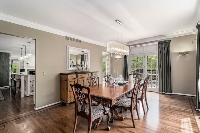 975 Pine Needle Trl, Rochester, MI 48306 - dining area with crown molding, healthy amount of natural light, dark wood finished floors, and baseboards