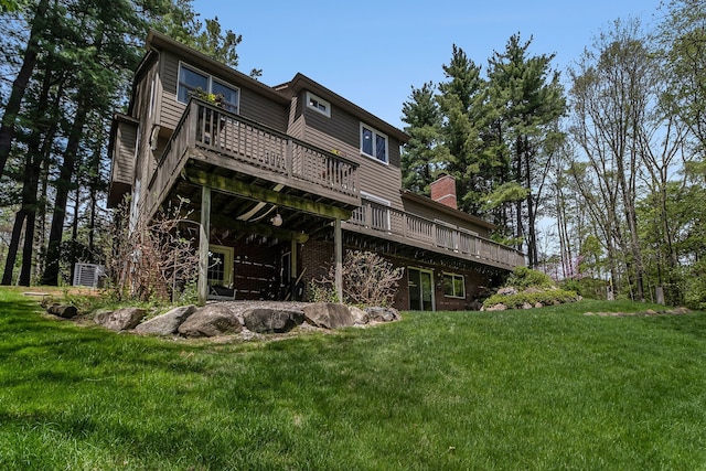 975 Pine Needle Trl, Rochester, MI 48306 - back of house featuring a wooden deck and a lawn