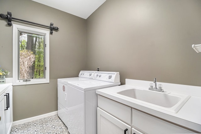 975 Pine Needle Trl, Rochester, MI 48306 - laundry room featuring cabinet space, washer and dryer, light tile patterned floors, and baseboards