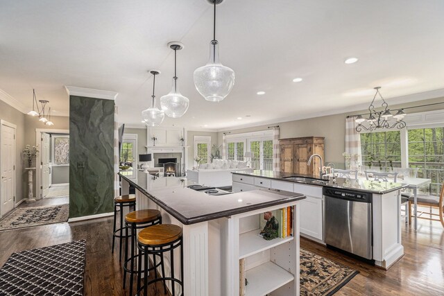 975 Pine Needle Trl, Rochester, MI 48306 - kitchen with stainless steel dishwasher, a sink, a spacious island, open floor plan, and dark wood finished floors