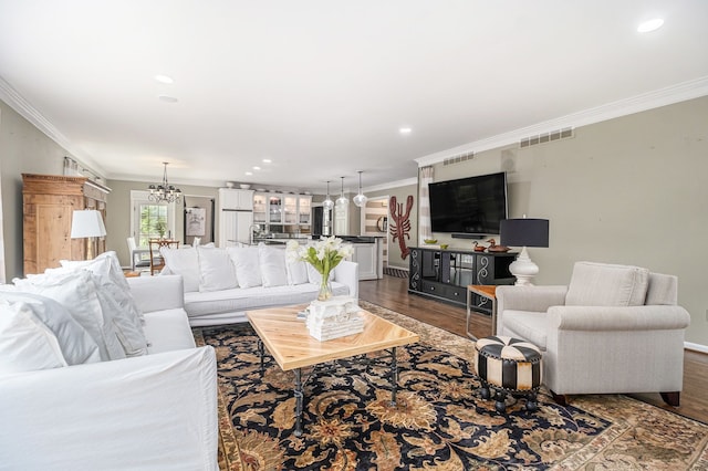 975 Pine Needle Trl, Rochester, MI 48306 - living area with dark wood finished floors, ornamental molding, baseboards, recessed lighting, and a chandelier