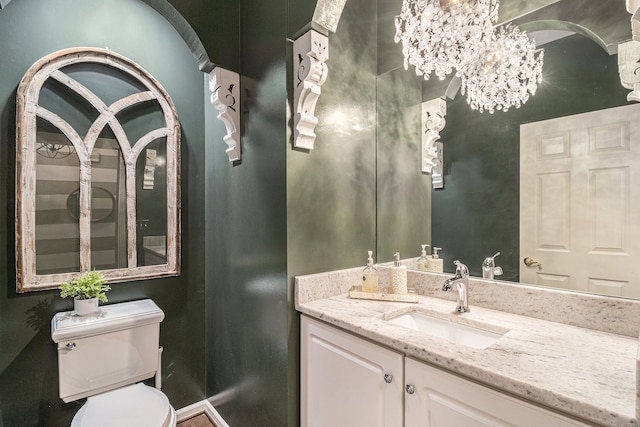 975 Pine Needle Trl, Rochester, MI 48306 - half bath featuring toilet, a chandelier, vanity, and baseboards