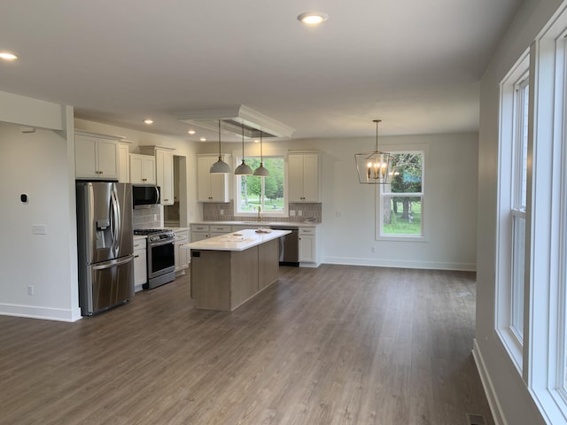 1060 N Wahington St, Lowell, MI 49331 - kitchen with appliances with stainless steel finishes, backsplash, dark wood-style flooring, light countertops, and recessed lighting