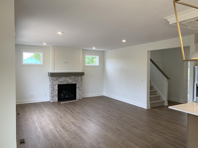 1060 N Wahington St, Lowell, MI 49331 - unfurnished living room featuring stairs, healthy amount of natural light, dark wood-style flooring, and recessed lighting