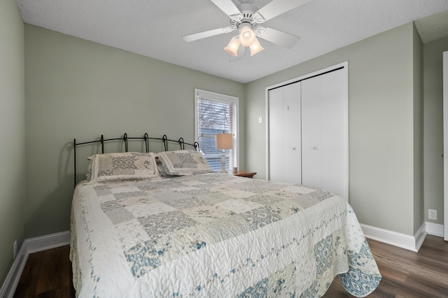 bedroom featuring a closet, ceiling fan, baseboards, and dark wood finished floors