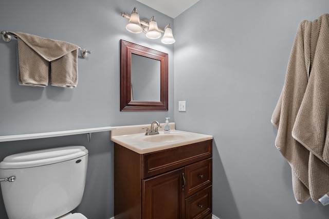 half bathroom with vanity and toilet