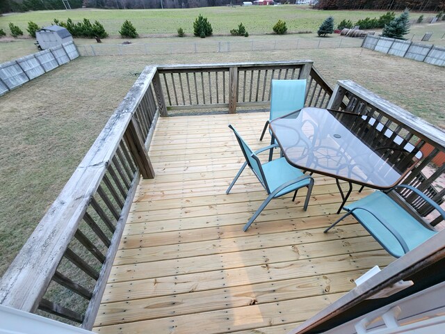 6039 W Morris Lake Rd, Mears, MI 49436 - wooden terrace featuring a lawn, a rural view, and outdoor dining area
